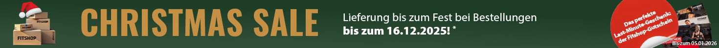 Ein weihnachtlicher Werbebanner mit grünem Hintergrund und einer Lichterkette am oberen Bildrand. Auf der linken Seite liegen mehrere Pakete mit der Aufschrift „Fitshop“. Daneben sind mehrere Fitshop-Geschenkgutscheine abgebildet. In einem rot hervorgehobenen Textfeld steht „Das perfekte Last-Minute-Geschenk: der Fitshop-Gutschein“. Auf der rechten Seite steht in Großbuchstaben „Christmas Sale“ sowie der Zusatz „Lieferung bis zum Fest bei Bestellungen bis zum 16.12.2025!“.